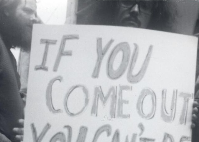 Man holding sign, "If you come out you can't be found out," John Kyper, 1971.