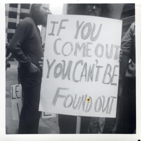 Attendee holds a sign that reads "IF YOU COME OUT YOU CAN'T BE FOUND OUT" during Boston's first Pride March, June 26, 1971