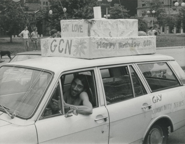 GCN Office Manager Ron Arruda driving GCN's first birthday cake in the Pride parade, June 1974, Photograph by John Kyper